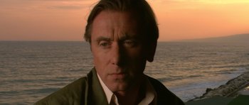 Movie still from “Youth Without Youth” (2007), directed by Francis Ford Coppola – A person near a body of water; Close Up shot, Low angle