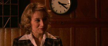 Movie still from “Youth Without Youth” (2007), directed by Francis Ford Coppola – A woman standing in front of a wall clock; Close Up shot, Over the shoulder angle