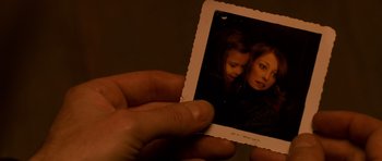 Movie still from “Youth Without Youth” (2007), directed by Francis Ford Coppola – A person holding an old photo of two people; Extreme Close Up shot, High angle