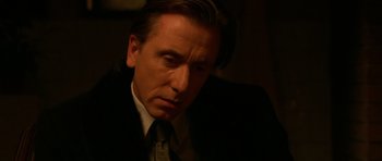Movie still from “Youth Without Youth” (2007), directed by Francis Ford Coppola – A person wearing a suit and tie; Close Up shot, High angle