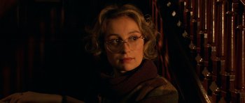 Movie still from “Youth Without Youth” (2007), directed by Francis Ford Coppola – A person wearing glasses and a sweater; Close Up shot, Over the shoulder angle