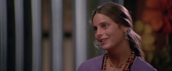 Movie still from “Zabriskie Point” (1970), directed by Michelangelo Antonioni – A young woman wearing a purple shirt and a purple necklace; Close Up shot, Over the shoulder angle