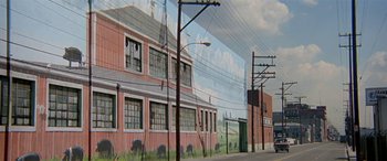 Movie still from “Zabriskie Point” (1970), directed by Michelangelo Antonioni – A mural of a train station on the side of a building; Extreme Wide shot, Low angle