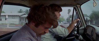 Movie still from “Zabriskie Point” (1970), directed by Michelangelo Antonioni – Two men sitting in the drivers seat of a car; Close Up shot, Low angle