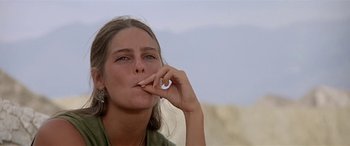 Movie still from “Zabriskie Point” (1970), directed by Michelangelo Antonioni – A person holding a cell phone up to their mouth; Close Up shot, Low angle