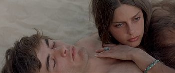 Movie still from “Zabriskie Point” (1970), directed by Michelangelo Antonioni – A man and a woman laying on a bed together; Close Up shot, High angle