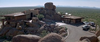Movie still from “Zabriskie Point” (1970), directed by Michelangelo Antonioni – An aerial view of a desert area with a large rock pile; Extreme Wide shot, High angle