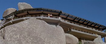 Movie still from “Zabriskie Point” (1970), directed by Michelangelo Antonioni – A cow standing on top of a building on top of a hill; Extreme Wide shot, Low angle