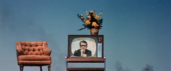 Movie still from “Zabriskie Point” (1970), directed by Michelangelo Antonioni – An old tv sitting on top of a wooden stand; Wide shot, Low angle