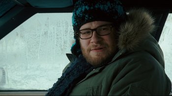 Movie still from “Zack and Miri Make a Porno” (2008), directed by Kevin Smith – A man with a beard wearing glasses and a winter hat; Close Up shot, Over the shoulder angle