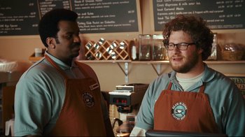 Movie still from “Zack and Miri Make a Porno” (2008), directed by Kevin Smith – Two men standing next to each other at a coffee shop; Medium shot, Over the shoulder angle