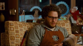 Movie still from “Zack and Miri Make a Porno” (2008), directed by Kevin Smith – A man sitting in a chair looking at a tablet; Medium shot, Over the shoulder angle