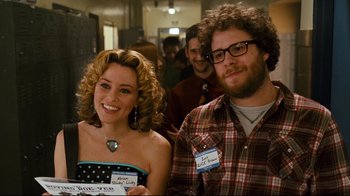 Movie still from “Zack and Miri Make a Porno” (2008), directed by Kevin Smith – A man and a woman smiling for the camera; Medium shot, Over the shoulder angle