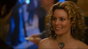 Movie still from “Zack and Miri Make a Porno” (2008), directed by Kevin Smith – A woman with blonde curly hair wearing a heart necklace; Close Up shot, Over the shoulder angle