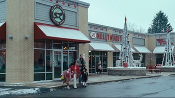Movie still from “Zack and Miri Make a Porno” (2008), directed by Kevin Smith – A group of people standing on the sidewalk in front of a store; Extreme Wide shot, High angle