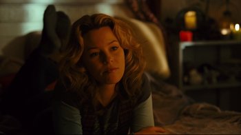 Movie still from “Zack and Miri Make a Porno” (2008), directed by Kevin Smith – A woman sitting on the ground in a room; Medium shot, Over the shoulder angle