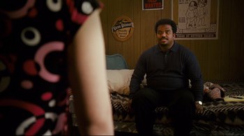 Movie still from “Zack and Miri Make a Porno” (2008), directed by Kevin Smith – A man sitting on top of a couch next to a woman; Medium shot, Over the shoulder angle