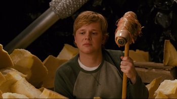 Movie still from “Zack and Miri Make a Porno” (2008), directed by Kevin Smith – A young man holding an object in his hand; Close Up shot, Over the shoulder angle