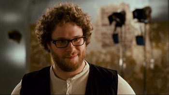 Movie still from “Zack and Miri Make a Porno” (2008), directed by Kevin Smith – A person wearing glasses and a beard; Close Up shot, Over the shoulder angle