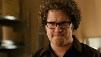 Movie still from “Zack and Miri Make a Porno” (2008), directed by Kevin Smith – A person wearing glasses and a brown shirt; Close Up shot, Over the shoulder angle