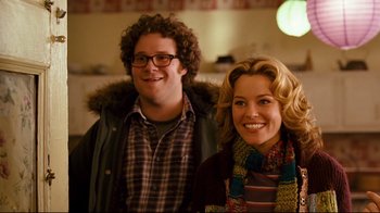 Movie still from “Zack and Miri Make a Porno” (2008), directed by Kevin Smith – A man and a woman posing for a picture; Medium shot, Over the shoulder angle