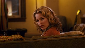 Movie still from “Zack and Miri Make a Porno” (2008), directed by Kevin Smith – A woman sitting on a couch in a living room; Close Up shot, Over the shoulder angle