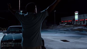 Movie still from “Zack and Miri Make a Porno” (2008), directed by Kevin Smith – A man standing in the middle of a street at night; Medium shot, Low angle