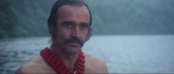 Movie still from “Zardoz” (1974), directed by John Boorman – A person wearing a necklace; Close Up shot, Over the shoulder angle