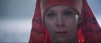 Movie still from “Zardoz” (1974), directed by John Boorman – A person wearing a red headscarf; Close Up shot, Low angle