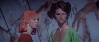 Movie still from “Zardoz” (1974), directed by John Boorman – Two women standing next to each other in front of a painting; Close Up shot, Low angle