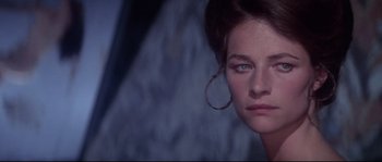 Movie still from “Zardoz” (1974), directed by John Boorman – A person wearing a hoop earring; Close Up shot, Over the shoulder angle