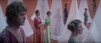 Movie still from “Zardoz” (1974), directed by John Boorman – A group of women standing next to each other in a room; Wide shot, Low angle