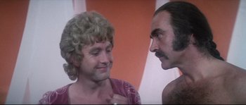 Movie still from “Zardoz” (1974), directed by John Boorman – A man and a woman talking to each other; Close Up shot, Over the shoulder angle