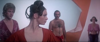 Movie still from “Zardoz” (1974), directed by John Boorman – A man and a woman standing next to each other; Medium shot, Low angle