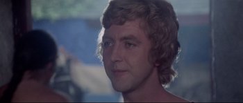 Movie still from “Zardoz” (1974), directed by John Boorman – A man's face in a dark room; Close Up shot, Low angle