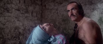 Movie still from “Zardoz” (1974), directed by John Boorman – A man standing next to a woman with a head covering; Close Up shot, Low angle