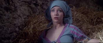 Movie still from “Zardoz” (1974), directed by John Boorman – A woman wearing a blue dress and a head scarf; Close Up shot, Low angle