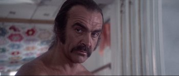 Movie still from “Zardoz” (1974), directed by John Boorman – A person with long hair; Close Up shot, Low angle