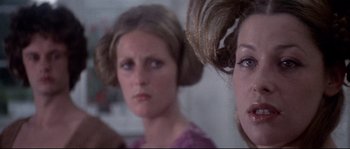 Movie still from “Zardoz” (1974), directed by John Boorman – Two women are looking at the camera in the mirror; Close Up shot, Over the shoulder angle