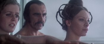 Movie still from “Zardoz” (1974), directed by John Boorman – A man and a woman looking at each other in a mirror; Close Up shot, Over the shoulder angle