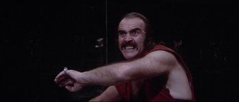 Movie still from “Zardoz” (1974), directed by John Boorman – A man with a beard and a red shirt; Close Up shot, Low angle