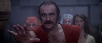 Movie still from “Zardoz” (1974), directed by John Boorman – A person with a beard wearing a red robe; Close Up shot, Over the shoulder angle