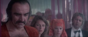 Movie still from “Zardoz” (1974), directed by John Boorman – A group of people standing next to each other on a train; Close Up shot, Over the shoulder angle