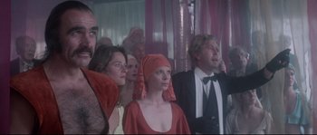 Movie still from “Zardoz” (1974), directed by John Boorman – A group of people standing in front of a curtain; Medium shot, Low angle