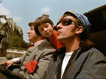 Movie still from “Zazie dans le Métro” (1960), directed by Louis Malle – A group of young men standing next to each other; Medium shot, Low angle