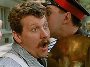 Movie still from “Zazie dans le Métro” (1960), directed by Louis Malle – A man with his mouth wide open looking at another man with his mouth wide open; Close Up shot, Over the shoulder angle