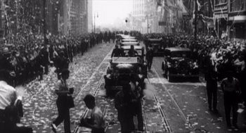 Movie still from “Zelig” (1983), directed by Woody Allen – A black and white photo of a city street with a crowd of people; Extreme Wide shot, High angle