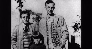 Movie still from “Zelig” (1983), directed by Woody Allen – An old photo of two men and a girl; Medium shot, High angle