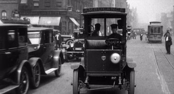 Movie still from “Zelig” (1983), directed by Woody Allen – An old photo of an ambulance driving down the street; Wide shot, Low angle