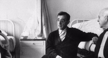 Movie still from “Zelig” (1983), directed by Woody Allen – A man sitting on a chair in a room; Close Up shot, Low angle